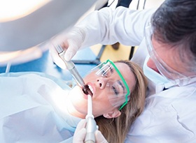 emergency dentist in Covina examining a patient’s mouth 