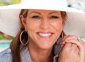 Smiling woman wearing large sun hat