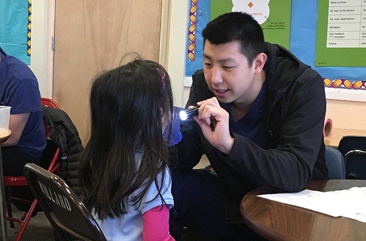 Dr. Tran looking in child's mouth