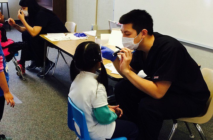 Dr. Tran examining a young child