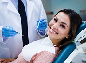 Woman smiling while visiting cosmetic dentist in Covina