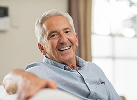 older man smiling after getting dental implants in Covina