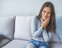 Closeup of woman struggling with toothache at home
